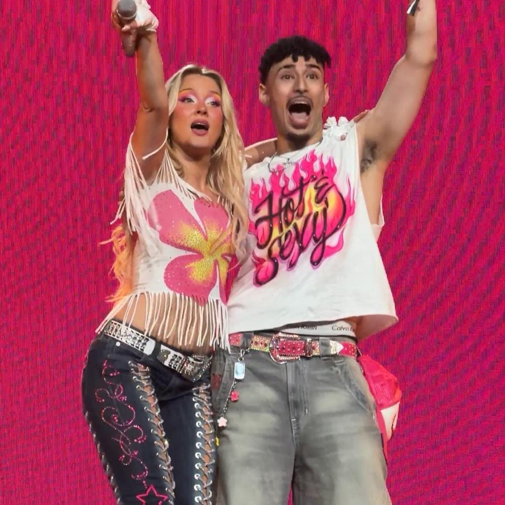 Customer wearing the Hot & Sexy Neon Flames airbrushed design while taking a photo with Zara Larsson on stage.
