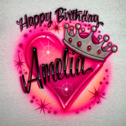 Personalized Happy Birthday airbrush shirt with custom name, pink heart, jeweled silver crown and starburst accents