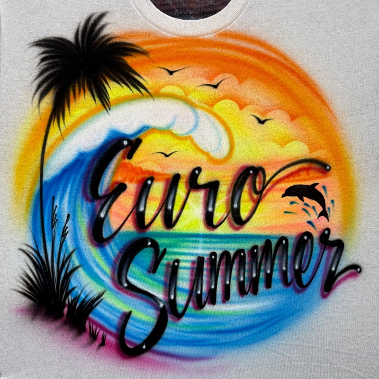 Hand-airbrushed Euro Summer shirt with ocean wave, sunset sky, palm trees, and dolphin silhouette, fan-inspired artwork by Fresh Air Shirts
