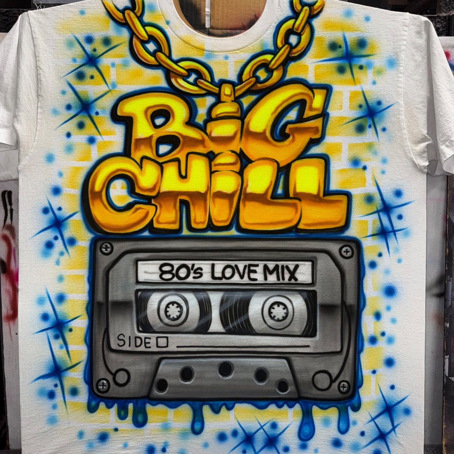 Airbrushed Big Chill full-front shirt with gold chain lettering and 80s Love Mix cassette tape in bright yellow, blue, and gray