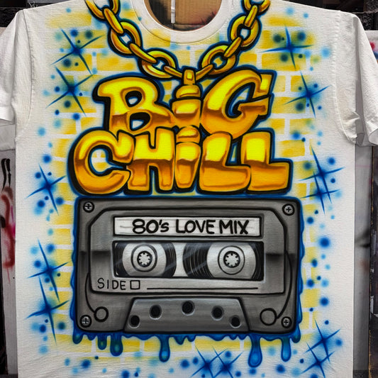 Airbrushed Big Chill full-front shirt with gold chain lettering and 80s Love Mix cassette tape in bright yellow, blue, and gray