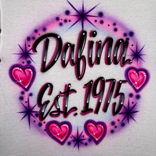 Personalized airbrush shirt with name and Est. year surrounded by hearts and starbursts, custom handmade design.