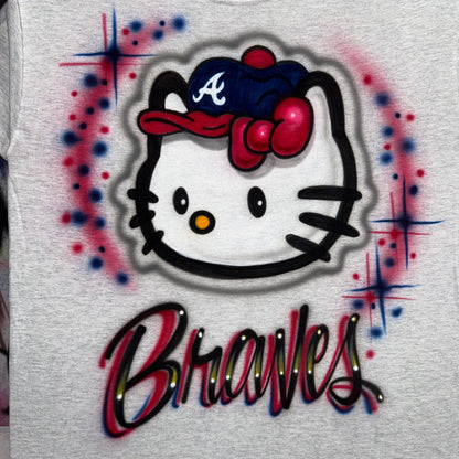 Hand-airbrushed Hello Kitty-inspired baseball shirt with Braves-inspired team colors, baseball cap, lettering and starburst accents