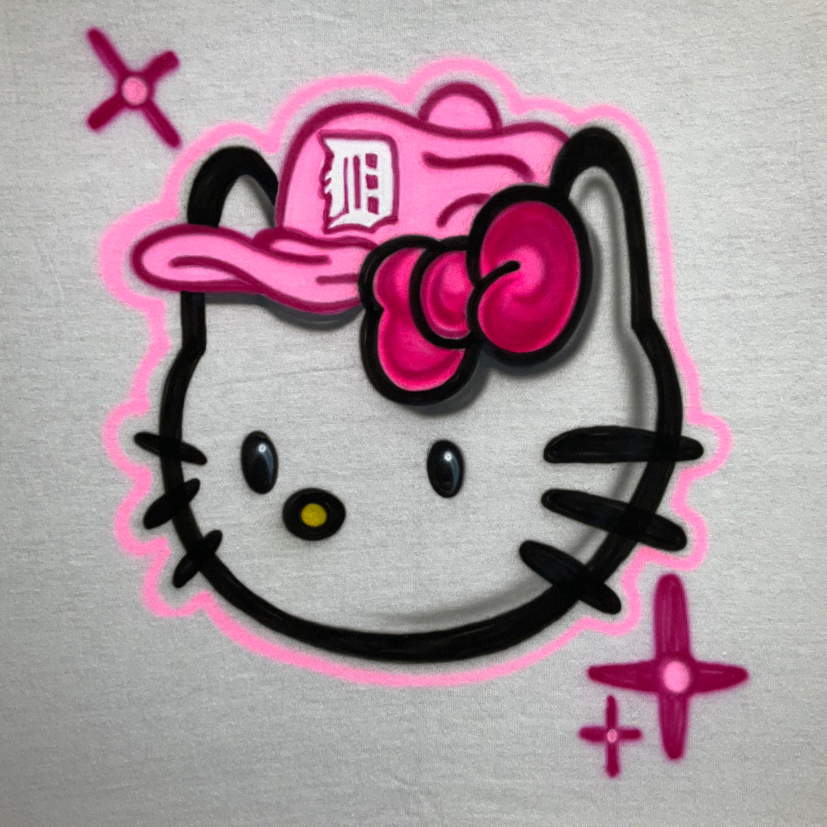 Hand-airbrushed Hello Kitty-inspired baseball shirt with pink Tigers-inspired cap, lettering and starburst accents