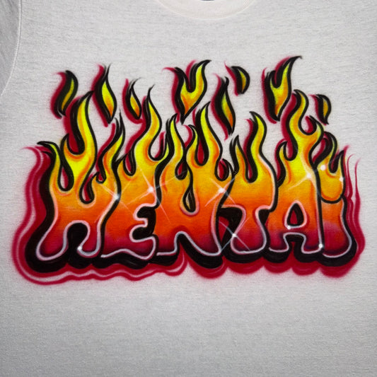 Airbrushed Hentai shirt with bold block letters and fiery flame design in yellow, orange, and red tones