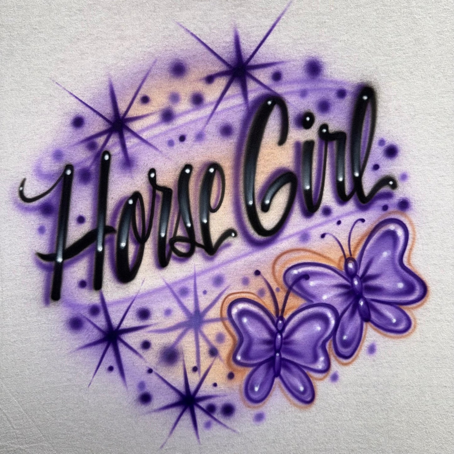 Horse Girl airbrushed shirt featuring custom script text, purple butterflies, sparkles, and hand-painted airbrush details
