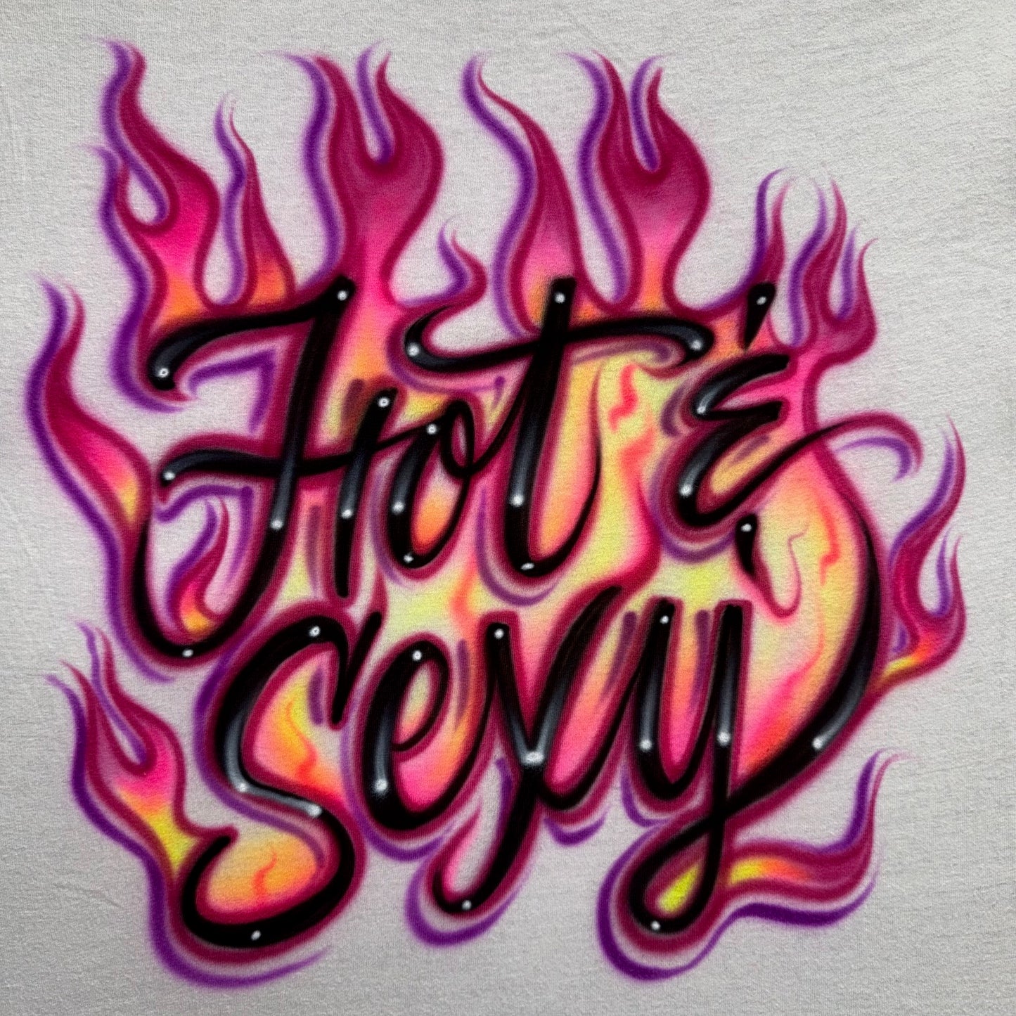 Airbrushed Hot & Sexy lettering surrounded by neon yellow, pink, fuchsia, and purple flames inspired by Zara Larsson’s Midnight Sun track.