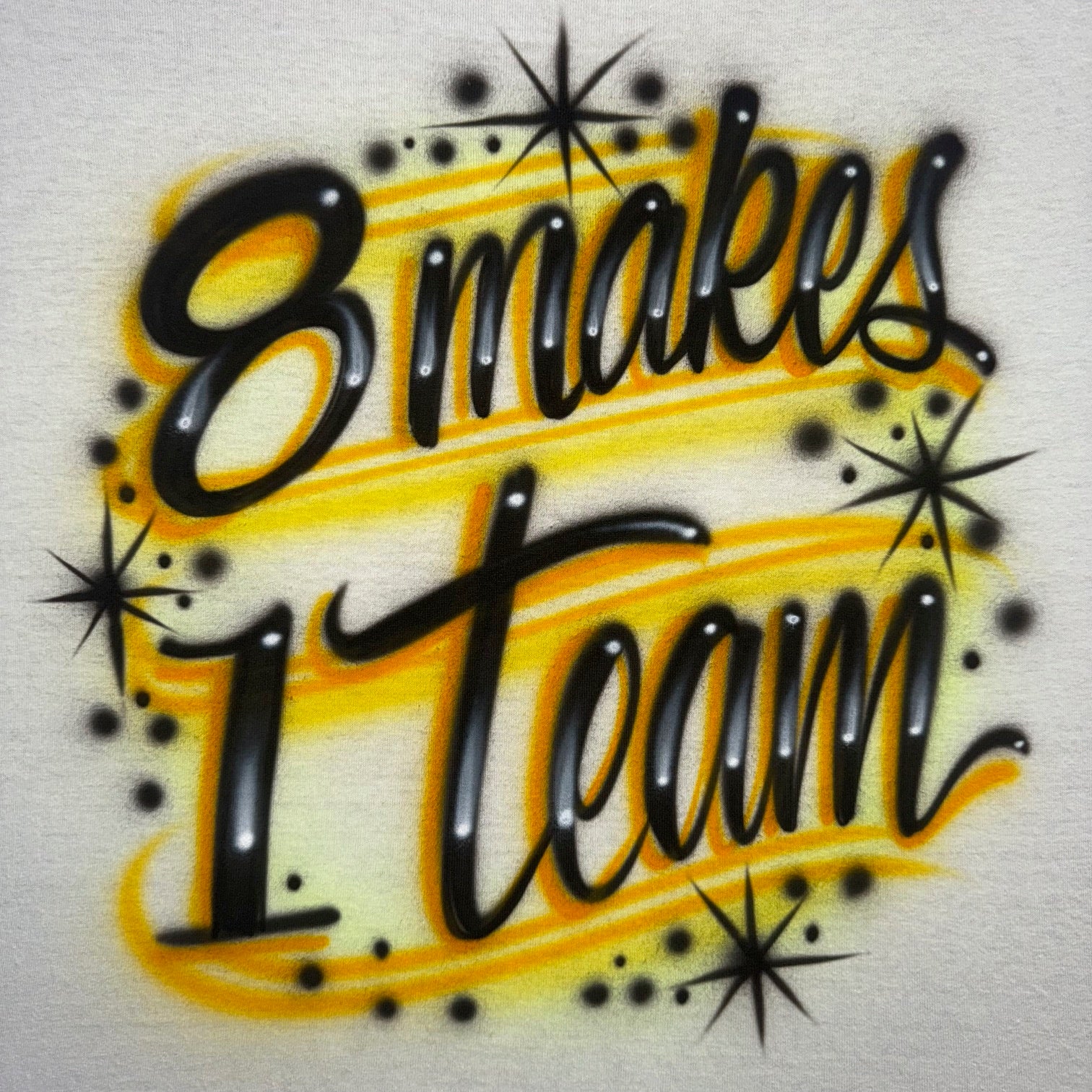 Decorative text '8 makes 1 team' with black and yellow design on a light background