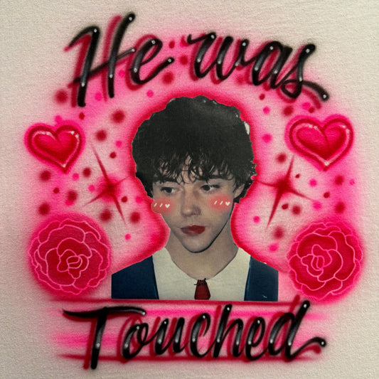Fan-inspired airbrushed shirt featuring a photo transfer portrait surrounded by hearts, carnations, and hand-painted glow effects