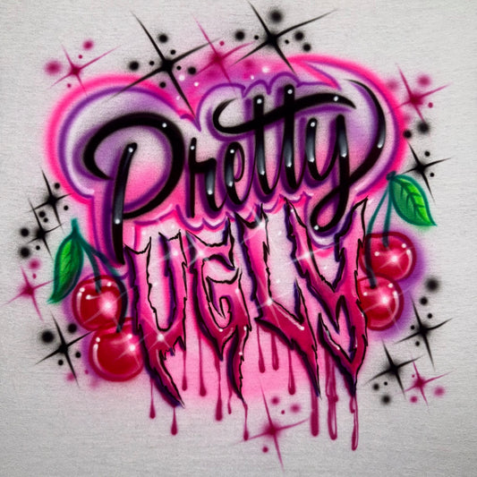Airbrushed Pretty Ugly shirt inspired by Zara Larsson’s concert look, with whimsical and drippy lettering, cherries, sparkles, and pink and purple tones