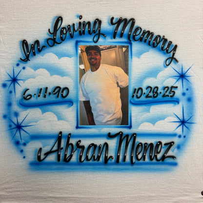 Airbrushed memorial shirt with clouds, stars, custom name, dates, and a photo transfer in the center.