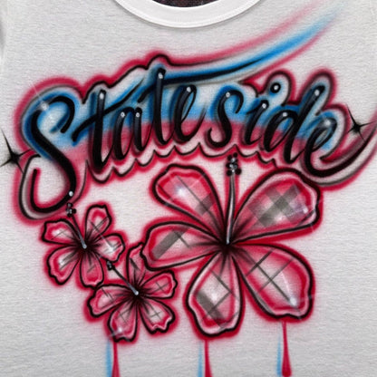 Hand-airbrushed Stateside shirt with three red plaid hibiscus flowers, black script lettering, blue highlights, subtle pink accents and starbursts